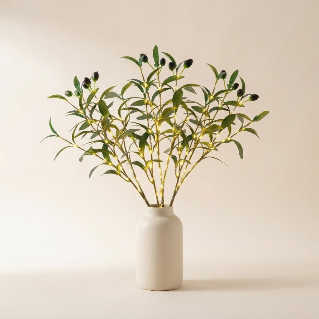 Styled illustration: bunch of 3 lit faux olive stems with warm-white LEDs in a cream vase on a warm cream studio background (vase not included)