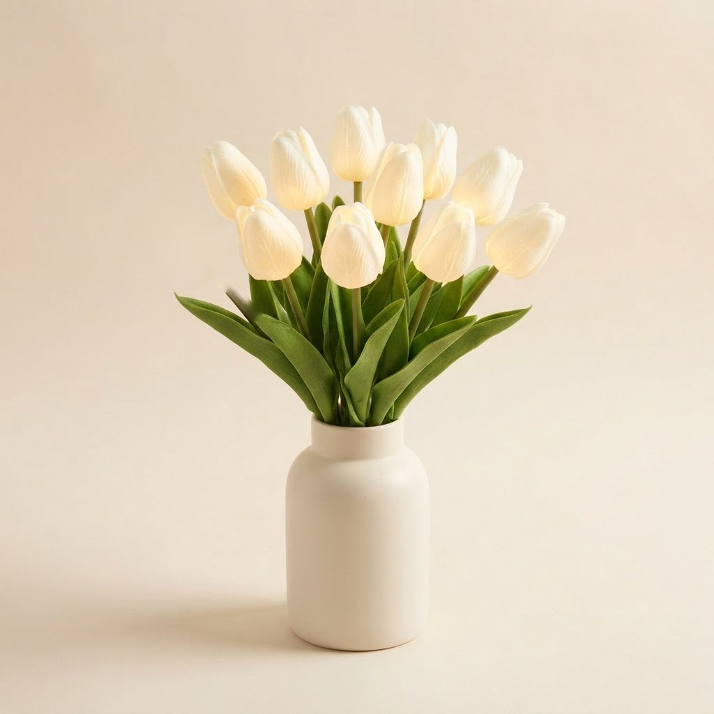 Styled illustration: 10 milk-white lit faux tulips in a cream vase on a warm cream studio background (vase not included)